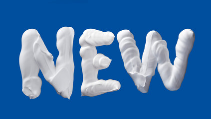 NEW word lettering made of shaving foam letters on blue background, writing with white foam