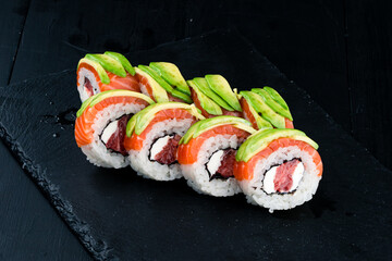Sushi rolls with tuna, salmon, cream cheese and avocado.