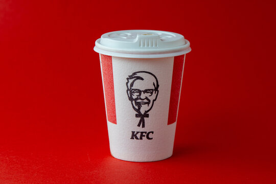 Red white glass of KFC for coffee, cocoa, tea on a red background. Hot drink to go. Kentucky Fried Chicken logo. Fast food restaurant. Harland Sanders Ukraine, Kyiv - November 10, 2022.
