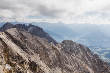 alpine mountain views strewn with snow under a blue sky