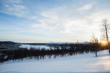 Fototapeta na wymiar Winter Lascape in Northern Sweden At Sunset