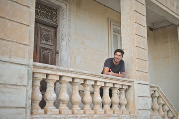 portrait of young man waiting for someone on the entrance of the