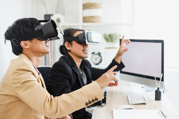 IT manager experiencing virtual reality at office with partner, young businessman using newest VR glasses, gesturing touching. 