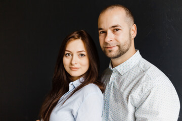 man and a woman in love pose for a family portrait, hugging