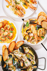 four different seafood dishes in the table