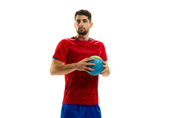 Motivated athlete. Portrait of young man, professional handball playing in uniform posing with ball isolated over white studio background. Concept of sport, motion, championship, sportive lifestyle