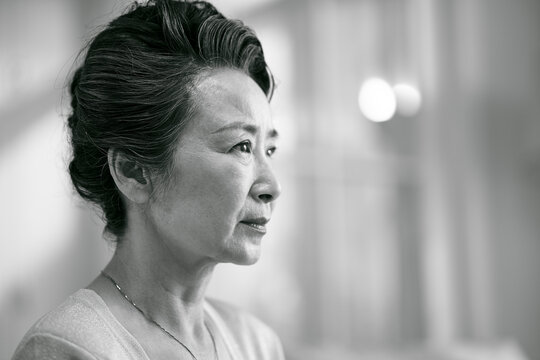 head shot portrait of a sad asian senior woman