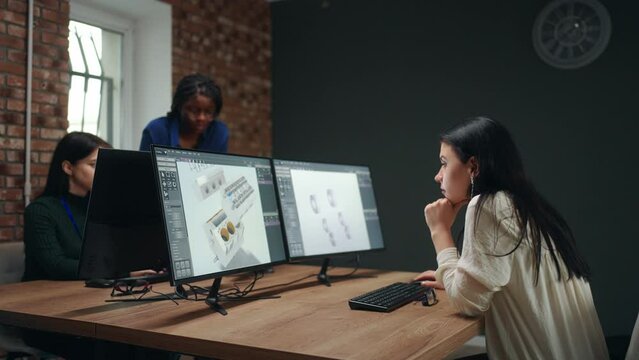 female workers in office of engineering department, black caucasian indian women creating 3D models