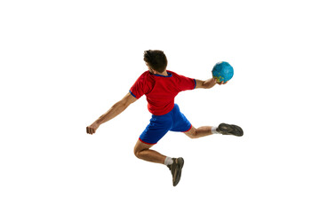 Goal. Back view studio shot of young man, professional handball player training, playing isolated over white background. In motion. Concept of sport, action, motion, championship, sportive lifestyle