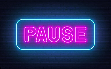 Pause neon sign on brick wall background.