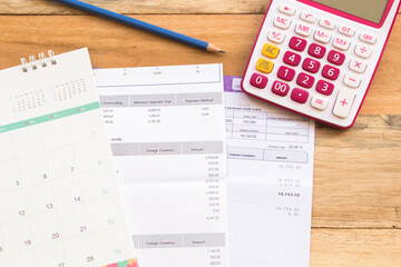 statement of bank, calendar and calculator business work arrangement flat lay style on background wooden