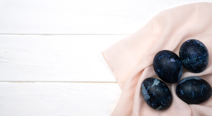 Blue Easter eggs on the white wooden background. Banner. Close-up. Top view. Copy space. Selective focus.