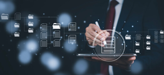 Businessman working on laptop and touch screen Online documentation database, IT consultant being set up Virtual Document Management System with laptop,Software for archiving corporate files.