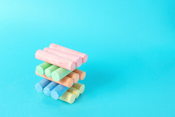 Color set with pieces chalk on blue background. School and creative concept.