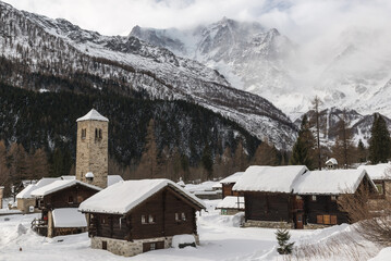 Snowy winter landscape of the Italian Alps with old fashioned wooden huts. Macugnaga, important ski...