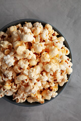 Homemade Kettle Corn Popcorn with Salt in a Bowl, top view. Flat lay, overhead, from above. Close-up.
