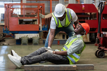 Industrial accident concept. Male african american accidents from working carrying heavy objects on...
