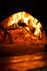 Traditional Italian pizza oven with wooden sticks fire outside in a cafe or restaurant 