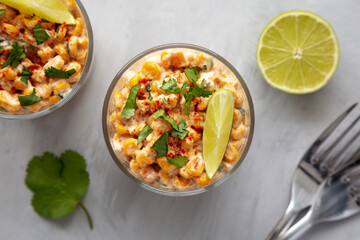 Homemade Mexican Corn Elote Esquites in Cups, top view. Flat lay, overhead, from above. Close-up.
