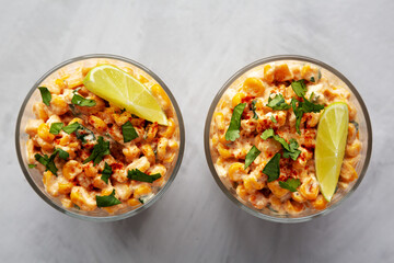 Homemade Mexican Corn Elote Esquites in Cups, top view. Flat lay, overhead, from above. Close-up.