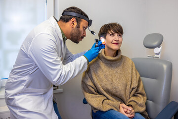 ENT doctor examinine patients ear with endoscope