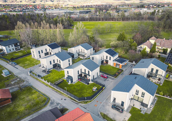 Aerial view of new modern residential area with identical white houses 