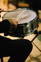 A member of a marching band plays the drums during a concert