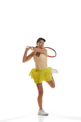 Dynamic portrait of young teen girl, tennis player in sports uniform in action, motion isolated over white background. Concept of sport, fashion, motivation, education and achievement