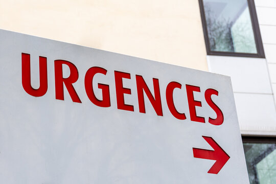 Enseigne avec le mot "URGENCES" &eacute;crit en rouge en Fran&ccedil;ais indiquant la direction du service des urgences dans un h&ocirc;pital en France