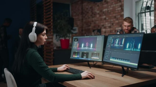 diverse people work in post-production video studio, woman movie editor making final cut of clip