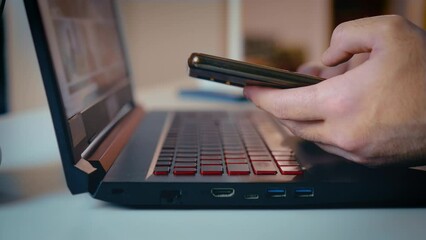 Male hands using laptop touchpad and keyboard close up. Business man scrolling websites, searching examples advertisement reference. Freelancer entrepreneur working online with pc software apps