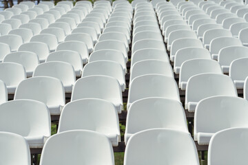 Obraz premium Seats of tribune on sport stadium. Concept of fans, chairs for audience, cultural environment concept. mpty seats, modern stadium.