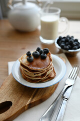 delicious homemade pancakes with blueberries on wooden background