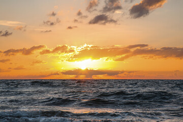 Picturesque view of sea under sky at beautiful sunset