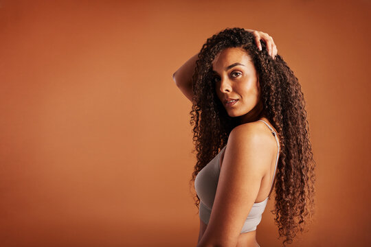 Young black with woman posing in underwear on an orange background