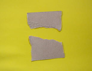 Set of torn paper pieces isolated on yellow background