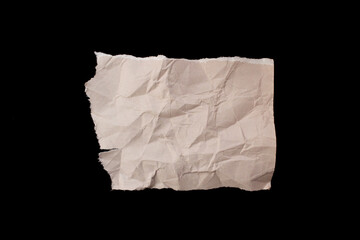 Fototapeta premium Crumpled torn paper piece isolated on black background