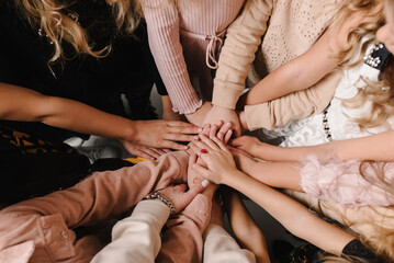 Kids putting their hands together. Many children's hands holding together as a team. Ukrainian people peaceful. Gesture of peaceful relationship of nations. Independence Day of Ukraine. Stop the war.
