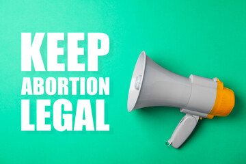Reproductive rights protest. Megaphone with slogan Keep Abortion Legal on aquamarine color...