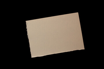 Torn paper piece isolated on black background. Ripped paper.