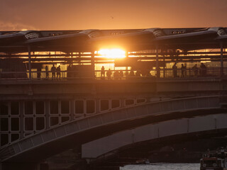 Silhouette of people on Millennium Bridge London