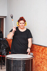 woman playing the drum with hearing protection