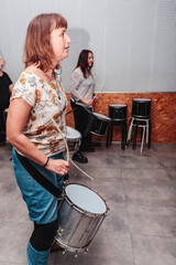 Girls playing the drum inside a studio