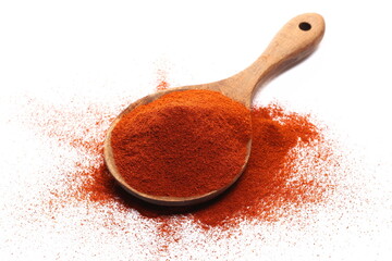 Red paprika, cayenne pepper powder in wooden spoon pile isolated on white, side view 