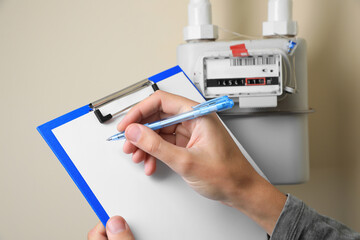 Man filling in gas receipt near counter, closeup