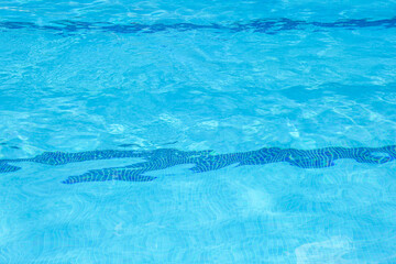 Outdoor swimming pool with clear rippled water