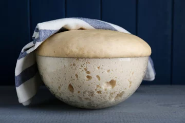 Gordijnen Bowl of fresh yeast dough on grey wooden table © New Africa
