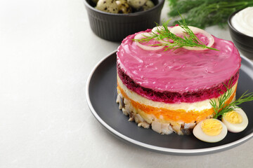 Herring under fur coat salad on light grey table, space for text. Traditional Russian dish