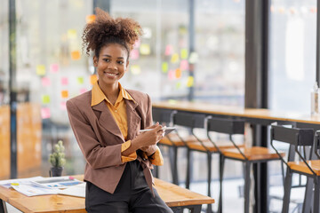 Black business woman using digital tablet in meeting room office workplace, business finance concept.