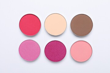 Beautiful eye shadow refill pans on white background, flat lay